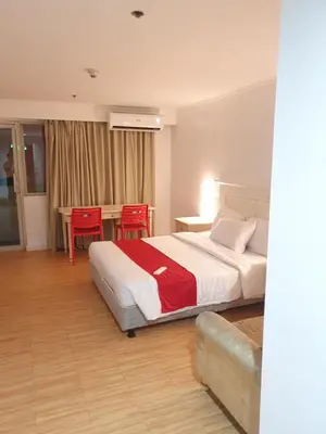 a bedroom with a bed and a table and chairs at SAB R.CONDOTEL and room rental in Manila