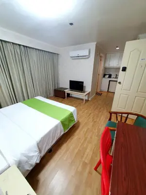 a bedroom with a bed and a television in it at SAB R.CONDOTEL and room rental in Manila