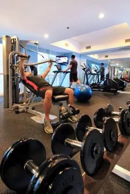 a man is in a gym with weights at SAB R.CONDOTEL and room rental in Manila