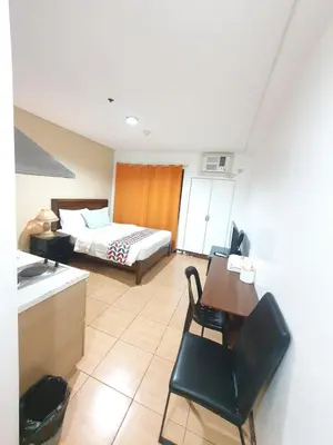 a hotel room with a bed and a table and chairs at SAB R.CONDOTEL and room rental in Manila