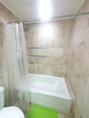 a bathroom with a bath tub and a toilet at SAB R. CONDOTE'L SUITES in Manila