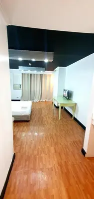 a large room with a bed and a table at SAB R. CONDOTE'L SUITES in Manila