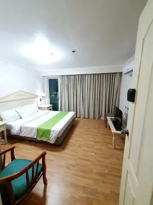 a hotel room with a large bed and a desk at SAB R. CONDOTE'L SUITES in Manila