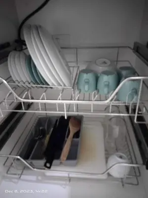 a drawer filled with plates and bowls and utensils at Deluxe Suites Razelles 2 at Shore 2 Residences Tower 1 in Manila