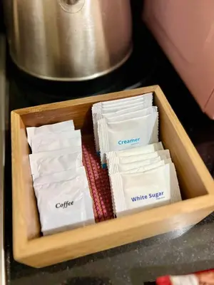 a wooden tray filled with white socks on a counter at Deluxe Suites Razelles 2 at Shore 2 Residences Tower 1 in Manila