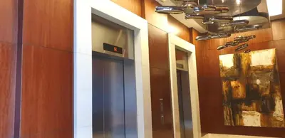 a hallway of a building with two mirrors on the wall at ETON BAYPARK MANILA by TRIPLE VIEW CONDOTEL in Manila