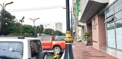 a street with cars parked next to a building at ETON BAYPARK MANILA by TRIPLE VIEW CONDOTEL in Manila