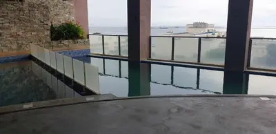 a building with a pool of water and windows at ETON BAYPARK MANILA by TRIPLE VIEW CONDOTEL in Manila