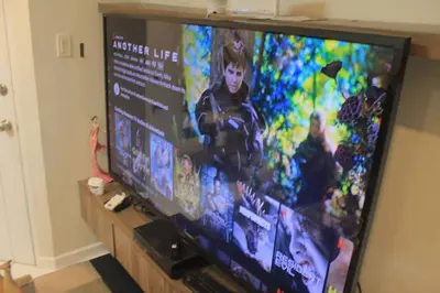 a large television screen with a video game on it at A2J Luxury 2BR Suite Near High Street BGC Taguig in Manila