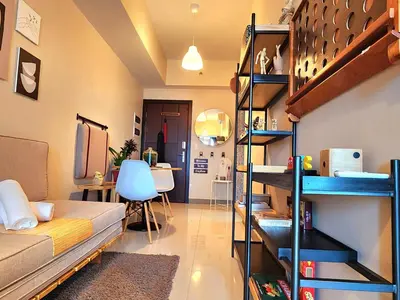 a room with bunk beds and a desk in it at 7 BGC Shopping Haven Steps Away from Uptown Mall and Mitsukoshi Mall FREE Parking with Washer in Manila