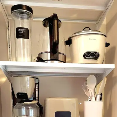 a shelf with a coffee pot and other kitchen items at 7 BGC Shopping Haven Steps Away from Uptown Mall and Mitsukoshi Mall FREE Parking with Washer in Manila