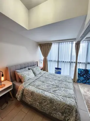 a bedroom with a bed and a large window at Cosy Executive 1 BR Uptown Parksuites Ultra fast Internet in Manila