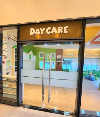 a display window of a day care store in a mall at Cosy Executive 1 BR Uptown Parksuites Ultra fast Internet in Manila