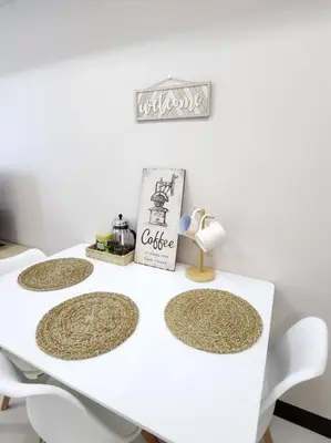 a white table with four plates on top of it at Cosy Executive 1 BR Uptown Parksuites Ultra fast Internet in Manila