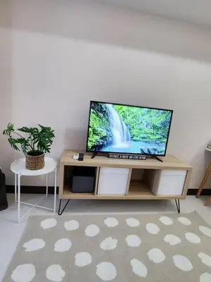 a flat screen tv sitting on top of a wooden table at Cosy Executive 1 BR Uptown Parksuites Ultra fast Internet in Manila
