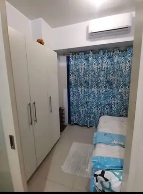 a small room with two beds and a curtain at Sea Residences Staycation Tanya's Condo Pasay in Manila