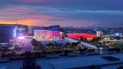 a city lit up at night with buildings and cars at Sea Residences Staycation by TVANS CONDOTEL Pasay City in Manila