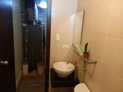 a small bathroom with a sink and a mirror at SLP Montecillo in Manila
