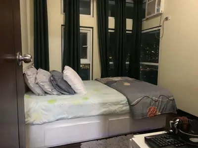 a bed in a room with a window at SLP Montecillo in Manila