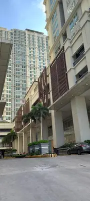 a parking lot in front of a large building at SLP Montecillo in Manila