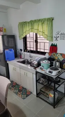 a kitchen with a sink and a counter top at Camilyn Home Stay in General Trias