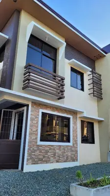 a house with a balcony in front of it at Camilyn Home Stay in General Trias
