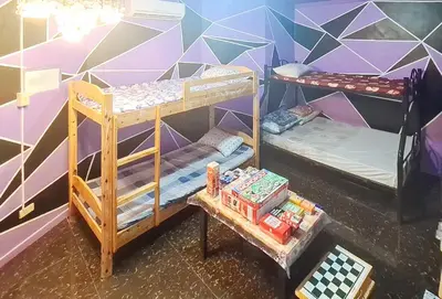 two bunk beds in a room with a wall at Yuzons Bedspacer and Transient Home Staycation in Manila