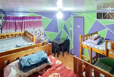 a bedroom with two bunk beds and a mural at Yuzons Bedspacer and Transient Home Staycation in Manila