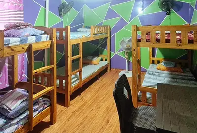 a room with bunk beds in it with a wall at Yuzons Bedspacer and Transient Home Staycation in Manila