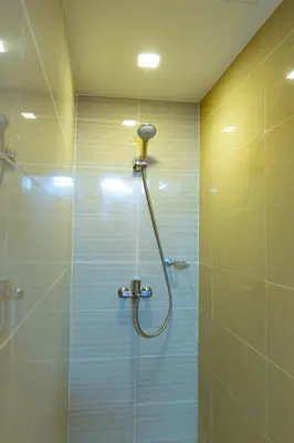 a shower with a shower head in a bathroom at Modern 1BR in Uptown BGC in Manila