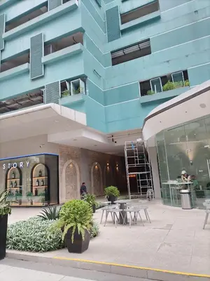 a blue building with tables in front of it at One Uptown Opposite of grandhyatt hotel manila Taguig city in Manila