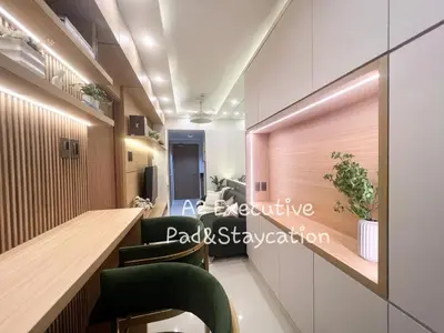 a waiting room with green chairs and a counter at A2 Executive Pad & Staycation in Manila