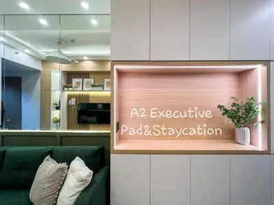 a sign for aania executive packet skylight in a living room at A2 Executive Pad & Staycation in Manila