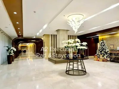a lobby with a christmas tree in the middle at A2 Executive Pad & Staycation in Manila