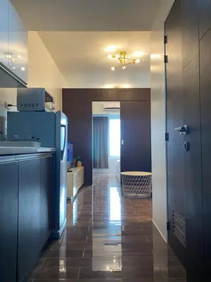 a kitchen with a refrigerator and a counter top at Air Residences 4439 in Manila