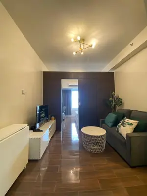 a living room with a couch and a tv at Air Residences 4439 in Manila