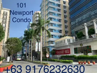 a city street with a sign for a newport condominium at 101 Newport condo in Pasay near airport in Manila