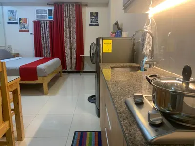 a kitchen with a sink and a bed in a room at 101 Newport condo in Pasay near airport in Manila