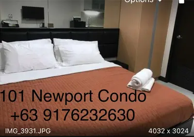 a hotel room with a bed with ahot newport control sign on it at 101 Newport condo in Pasay near airport in Manila