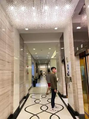a man standing in a hallway in a building at Comfy Artsy Studio in BGC in Manila