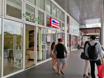a group of people walking through a shopping mall at R'Holistay Grace Taguig Fast Wifi Self Check In in Manila