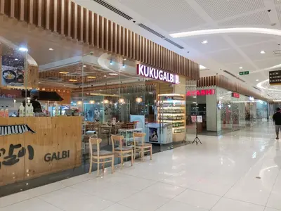 a shopping mall with tables and chairs in it at R'Holistay Grace Taguig Fast Wifi Self Check In in Manila
