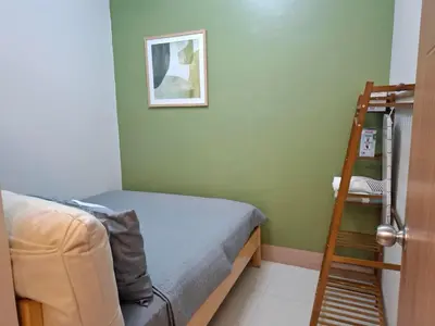 a bedroom with a bunk bed and a ladder at Shore Residences MOA by darpm in Manila
