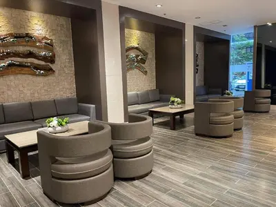 a lobby with couches and tables in a building at Shore Residences MOA by darpm in Manila