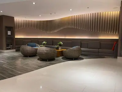 a lobby with a couch and chairs and a table at Shore Residences MOA by darpm in Manila