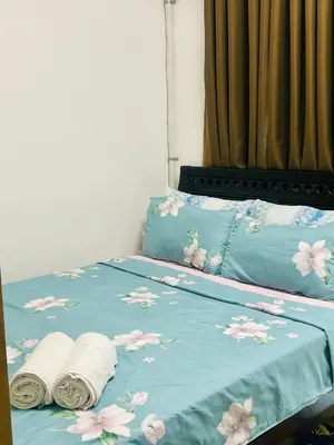 a bed with two towels on top of it at 1BR Homy Furnished Unit Grace Residences Taguig in Manila