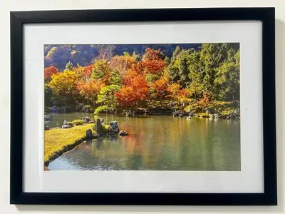 a framed picture of a lake in the fall at 1BR Homy Furnished Unit Grace Residences Taguig in Manila