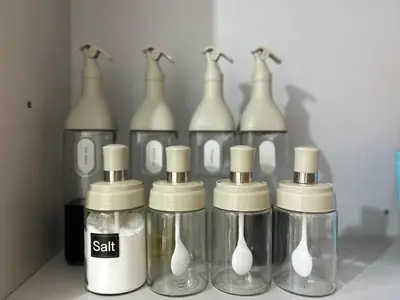 a group of glass bottles sitting on top of a shelf at 1BR Homy Furnished Unit Grace Residences Taguig in Manila