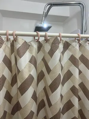 a shower curtain hanging on a towel rack at 1BR Homy Furnished Unit Grace Residences Taguig in Manila
