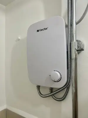 a water heater is attached to the wall of a bathroom at 1BR Homy Furnished Unit Grace Residences Taguig in Manila